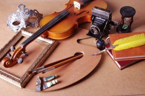 items from hobbies, violin, frame, paint brushes, mask, camera, feather pen