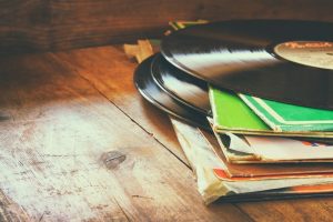 stack of records on a wooden table