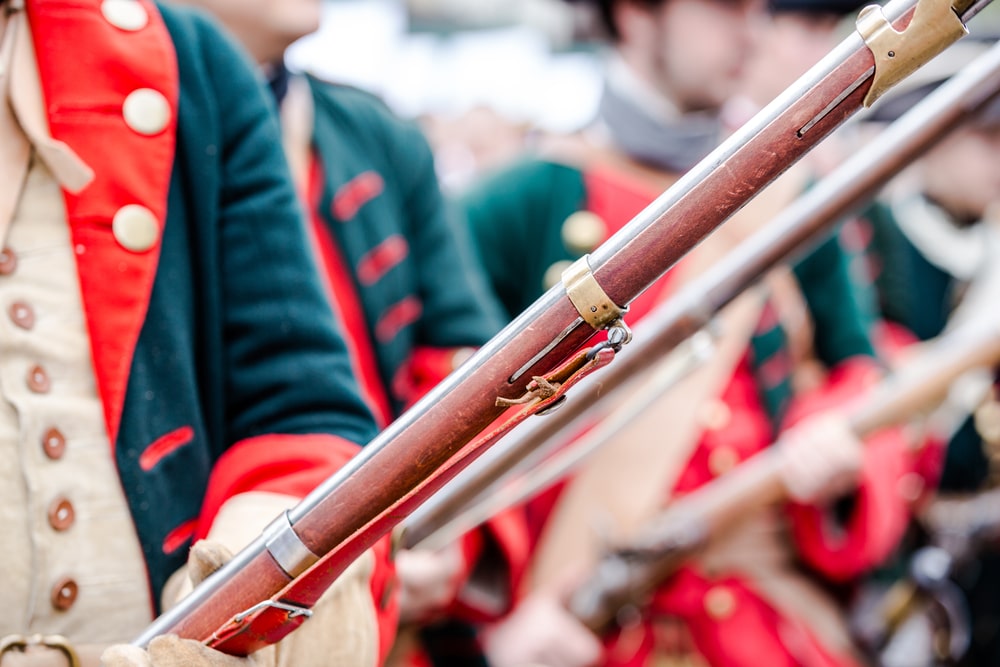 Soldiers dressed in Continental Army uniforms, holding rifles