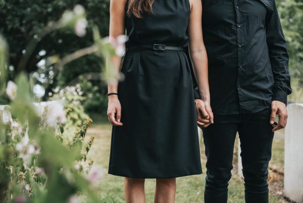 Couple holding hands at a graveyard