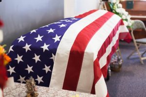 Casket draped with American flag at funeral service
