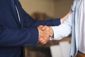 Two men shaking hands warmly