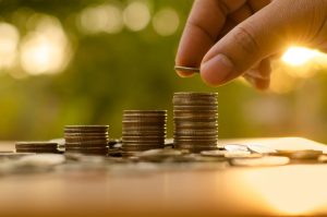 person stacking up quarters