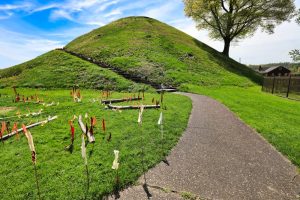 Grave Creek Mound, a green hill with a paved path heading toward it