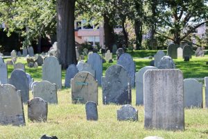 Charter Street Cemetery, many weathered tombstones in a green open space