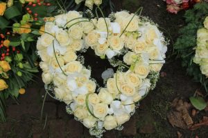 Heart-shaped funeral wreath of white flowers