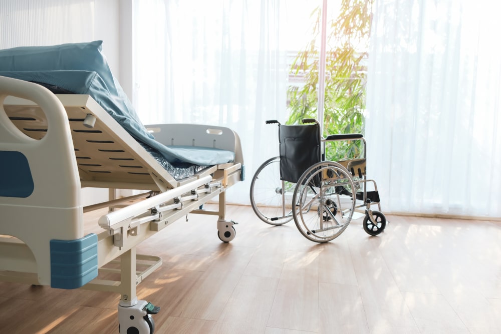 Open bright room with hospital bed and wheelchair