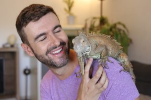 man with iguana on his shoulder