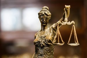 Close-up of Lady Justice, a blindfolded woman holding scales in her left hand