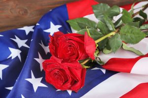 red roses on top of an American flag