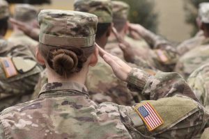 Group of service members salute