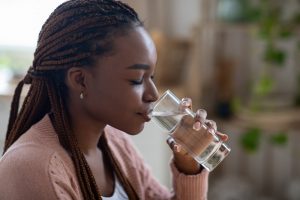 Young woman drinking a glass of water