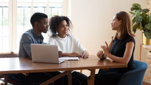 Young couple talking to funeral director about a loved one's advance funeral plan