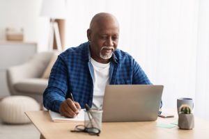 Older man looking at a laptop