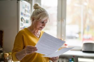 Woman in a yellow shirt looking at papers