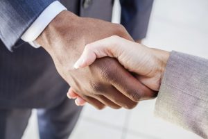 Funeral director shaking hands with a funeral guest or funeral officiant