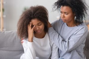 Mother comforting sad daughter 