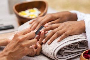 Woman receiving manicure on a self-care day