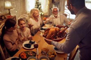 family sharing Thanksgiving dinner together