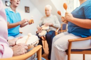 group of people in hospice playing music together