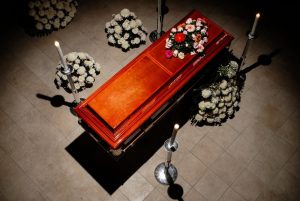 Aerial view of a casket with flower sprays set up around it