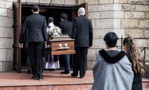 Procession as pallbearers carry casket into church for funeral service