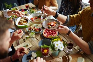 Group of people sharing food at a table