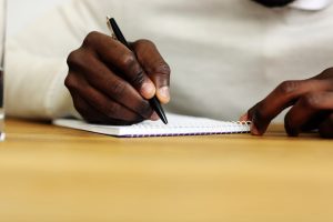 Man writing a letter to a long-distance friend