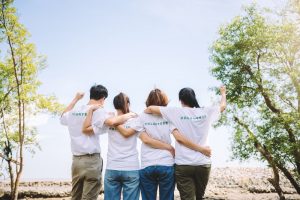 Group of volunteers looking out at trees