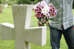 man visiting his mom's grave on Mother's Day