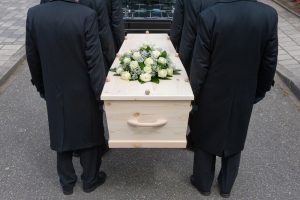 Pallbearers carrying wooden casket