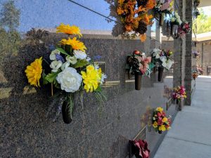 Outdoor mausoleum wall with memorial flowers