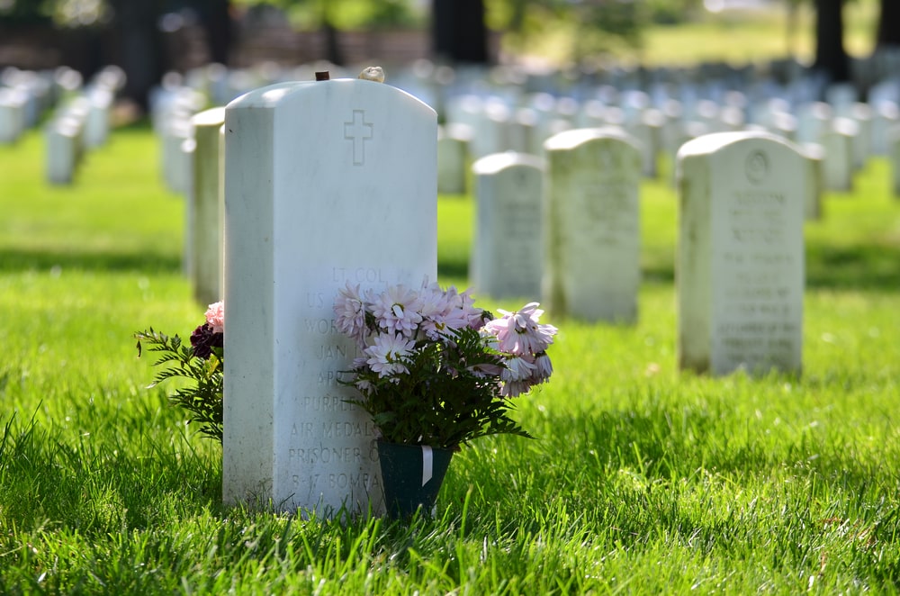 government-issued headstone with flowers