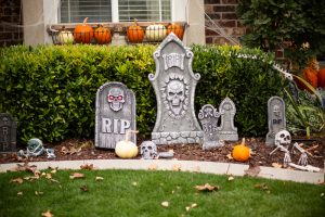 Tombstone and skull Halloween decorations outside a home