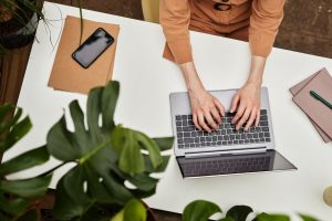 Looking down at woman typing on a laptop