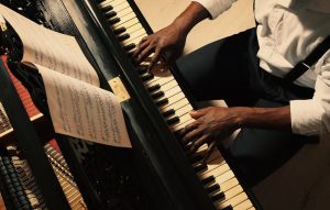 Man playing piano to honor a loved one