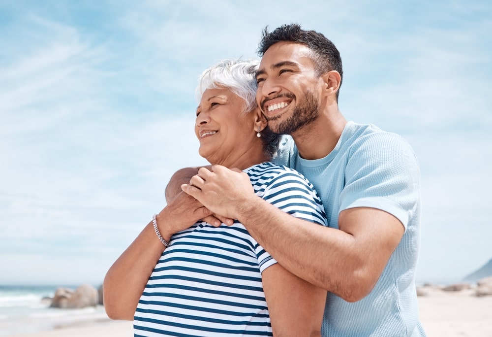 young man hugging elderly mother