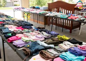 Estate sale clothing organized and neatly set out