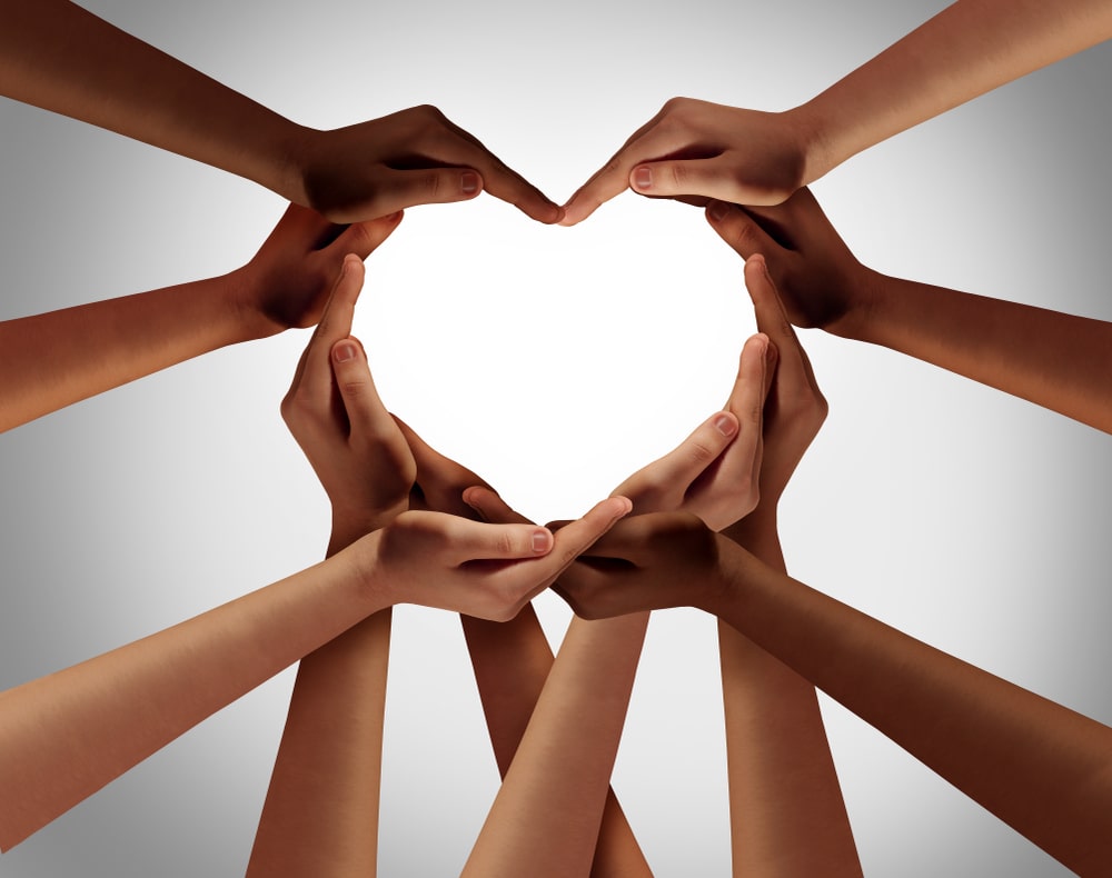 people holding their hands together to create a heart