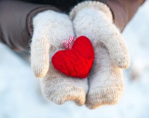 Person holding homemade heart plush in hands