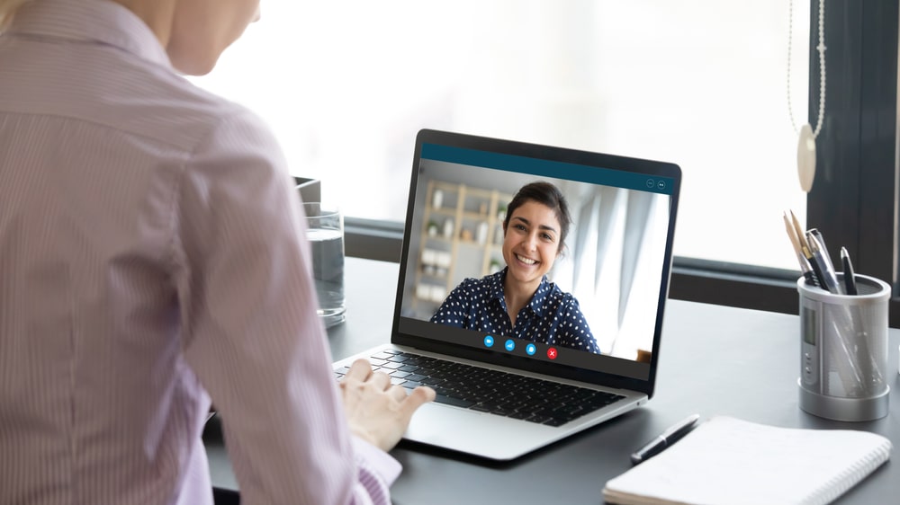 man attending online therapy on his laptop