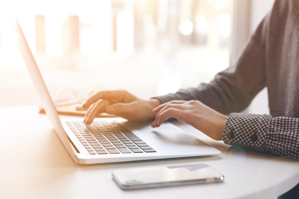 person typing on a laptop