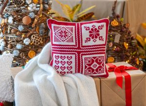 Red and white pillow sitting gifts and a Christmas display