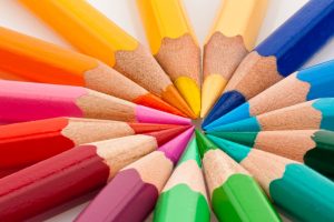 Colored pencils arranged in a circle with tips touching in the middle