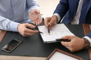 Two men reviewing living will documents together