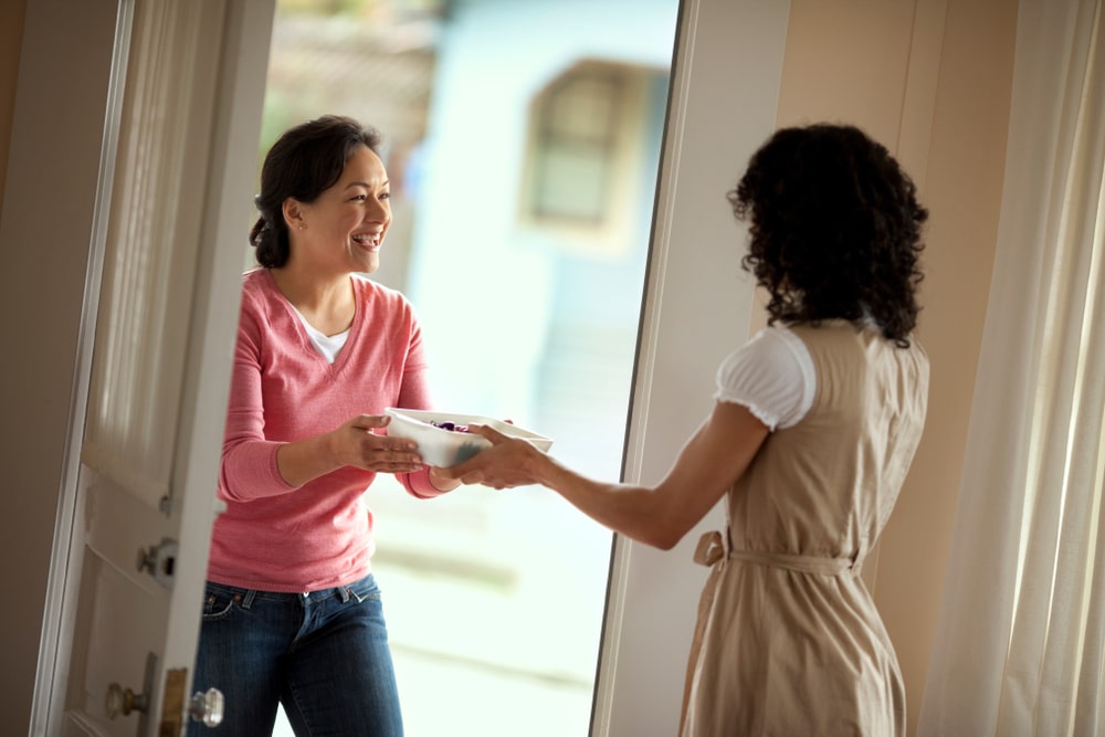 woman dropping off a meal for her friend