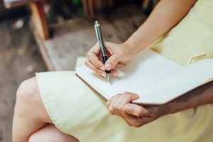woman writing in a notebook