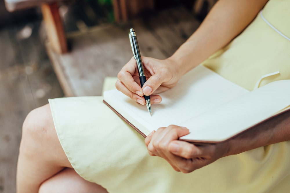 woman writing in a notebook