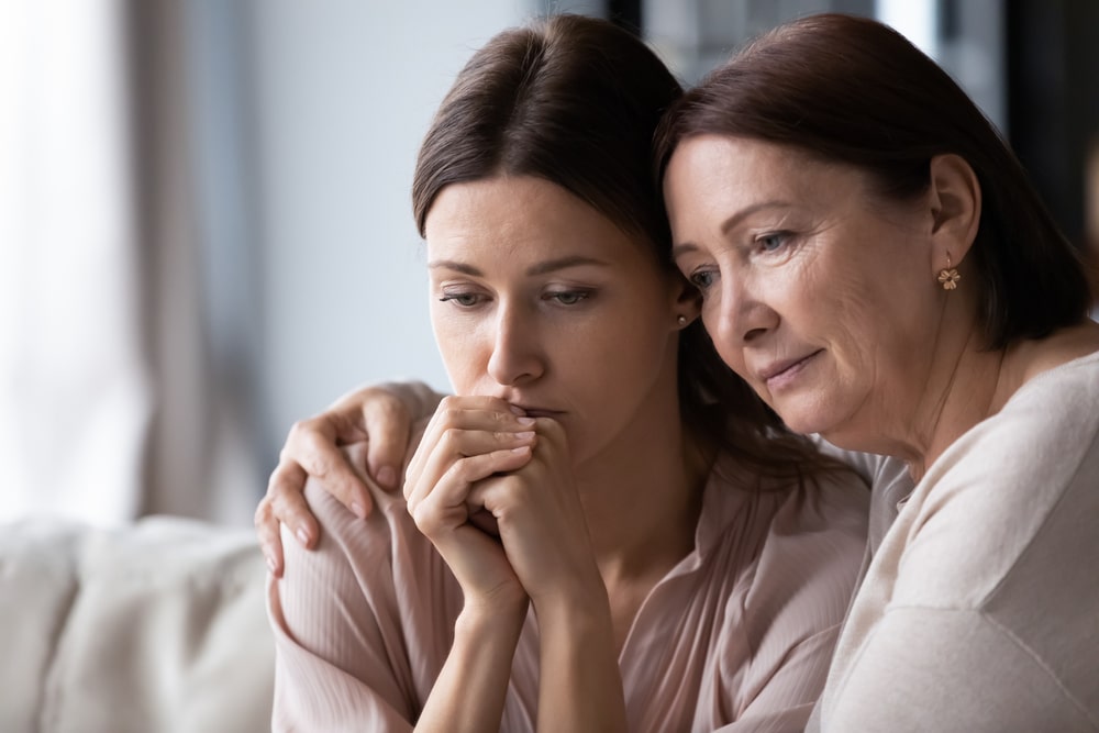 mother comforting her adult daughter