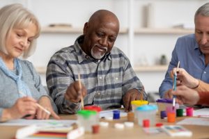 group of people in hospice doing art therapy